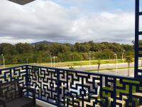 a balcony with a bench and a view of a park at COSTA MAR MARTIL TETOUAN in Martil