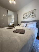 a bedroom with a large bed with towels on it at Apartman ANA in Vrlika