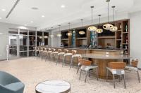 a bar with chairs and a table in a room at TownePlace Suites by Marriott Cape Canaveral Cocoa Beach in Cape Canaveral