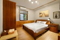 a bedroom with a bed and a table and a window at Li Jin Kuan Homestay in Nanzhuang