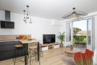 a kitchen and living room with a table and chairs at Superbe T2 Juan Les Pins 300m des plages in Antibes