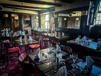 a dining room with tables and chairs and tablesktop at Rising Sun Hotel in Lynmouth