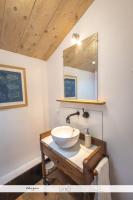 a bathroom with a bowl sink and a mirror at Le Nid des Anges, votre studio à la campagne. in Saint-Laurent-du-Plan
