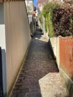 a brick alley with a fence next to a building at La Maison de l&#39;Auzette in Limoges