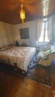 a bedroom with a large bed and a window at Chateau Mano in Mairé-lʼEveseault