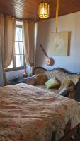 a bedroom with a large bed and a window at Chateau Mano in Mairé-lʼEveseault