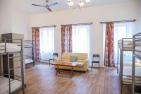 a living room with a couch and a table and two bunk beds at Hostel Little Quarter in Prague