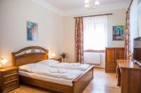 a bedroom with a large bed with a desk and a dresser at Hostel Little Quarter in Prague