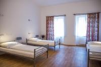 a room with three beds and two windows at Hostel Little Quarter in Prague