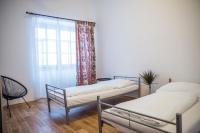 two beds in a room with a window at Hostel Little Quarter in Prague