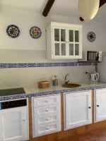 a kitchen with white cabinets and a sink at Molino El Mastral in Tarifa