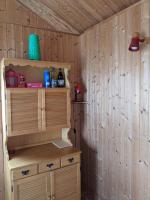 a room in a cabin with a wooden wall at Au petit chalet d&#39;Illiers Combray in Illiers