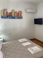A bed or beds in a room at VILLA AZZURRA beachfront Mondello - Palermo