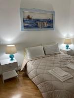 A bed or beds in a room at VILLA AZZURRA beachfront Mondello - Palermo