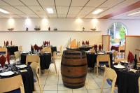 a wine tasting room with tables and a barrel at Azureva Ronce les Bains in Ronce-les-Bains