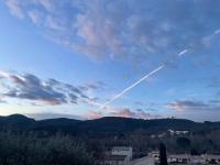 a jet trail in the sky over a city at Manoir d&#39;Amaury - Chambres d&#39;hôtes in Gréoux-les-Bains