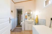 a white bathroom with a sink and a shower at Les Lavandes - Charmante maison avec terrasse in Pertuis