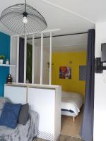 a bedroom with a bed and a yellow wall at Luz St Sauveur, Appartement 3 personnes, vue montagne, exposé sud, Résidence très calme in Luz-Saint-Sauveur