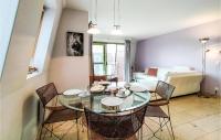 a dining room with a glass table and chairs at Nice Apartment In Bredene With Kitchen in Bredene