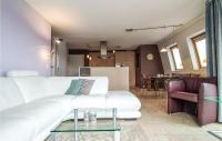 a living room with a white couch and a table at Nice Apartment In Bredene With Kitchen in Bredene