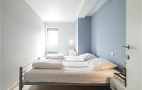 two beds in a room with blue walls at Nice Apartment In Bredene With Kitchen in Bredene