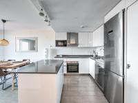 A kitchen or kitchenette at New beach front apartment with large balcony