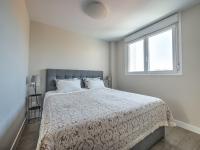 A bed or beds in a room at New beach front apartment with large balcony