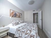 A bed or beds in a room at New beach front apartment with large balcony