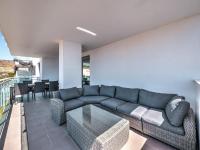 A seating area at New beach front apartment with large balcony