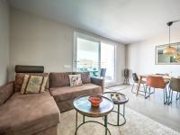 A seating area at New beach front apartment with large balcony