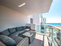 A seating area at New beach front apartment with large balcony