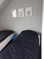 Łóżko lub łóżka w pokoju w obiekcie Les cottages du golf à Ploemel