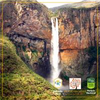 a waterfall on the side of a cliff at POUSADA VILA ACONCHEGO- Sossego- Em Meio Há Mata Nativa- by MARCOS MICOZZI in Serra do Cipo