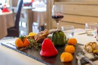 a plate of food on a table with a glass of wine at Le Vancouver in La Plagne