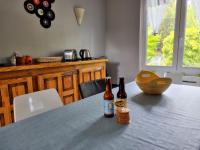 two bottles of beer sitting on a table in a kitchen at La Cabane aux Acacias~vacances nature et au calme in Mézos