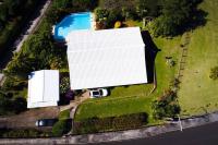 an overhead view of a large white building and a yard at YOU WELCOME VILLA in Case-Pilote