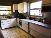 a kitchen with white appliances and two windows at YOU WELCOME VILLA in Case-Pilote