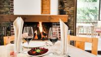 a table with wine glasses and a plate of food at Chalet Balkan in Valevtsi