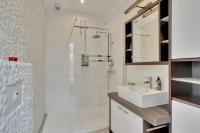 a white bathroom with a sink and a shower at Cosy appartement Kur 62 Hasselt in Hasselt