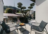 a balcony with chairs and a bowl of fruit on a table at Original Boutique Hotel in Tbilisi City