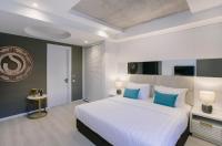 a bedroom with a large white bed with blue pillows at Original Boutique Hotel in Tbilisi City