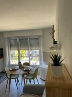 a living room with a table and chairs at APPARTEMENT COSY Balcon à 30min de PARIS in Cergy
