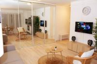 a living room with a large glass wall at APPARTEMENT COSY Balcon à 30min de PARIS in Cergy