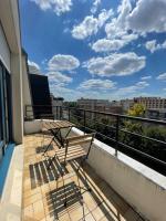 a balcony with a table and chairs on a building at APPARTEMENT COSY Balcon à 30min de PARIS in Cergy
