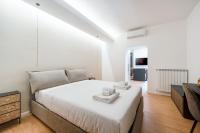 A bed or beds in a room at Bilocale Moderno - City Center