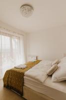 A bed or beds in a room at Hill View Apartment Tatragolf