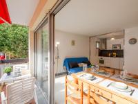 a kitchen and living room with a table and a couch at Apartment Le Grand Large-1 by Interhome in Sainte-Maxime