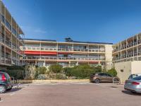 an apartment building with cars parked in a parking lot at Apartment Le Grand Large-1 by Interhome in Sainte-Maxime