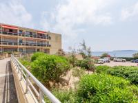 a building with a walkway next to a parking lot at Apartment Le Grand Large-1 by Interhome in Sainte-Maxime