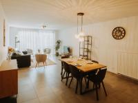 a dining room and living room with a table and chairs at Apartment Rodenbach by Interhome in De Haan